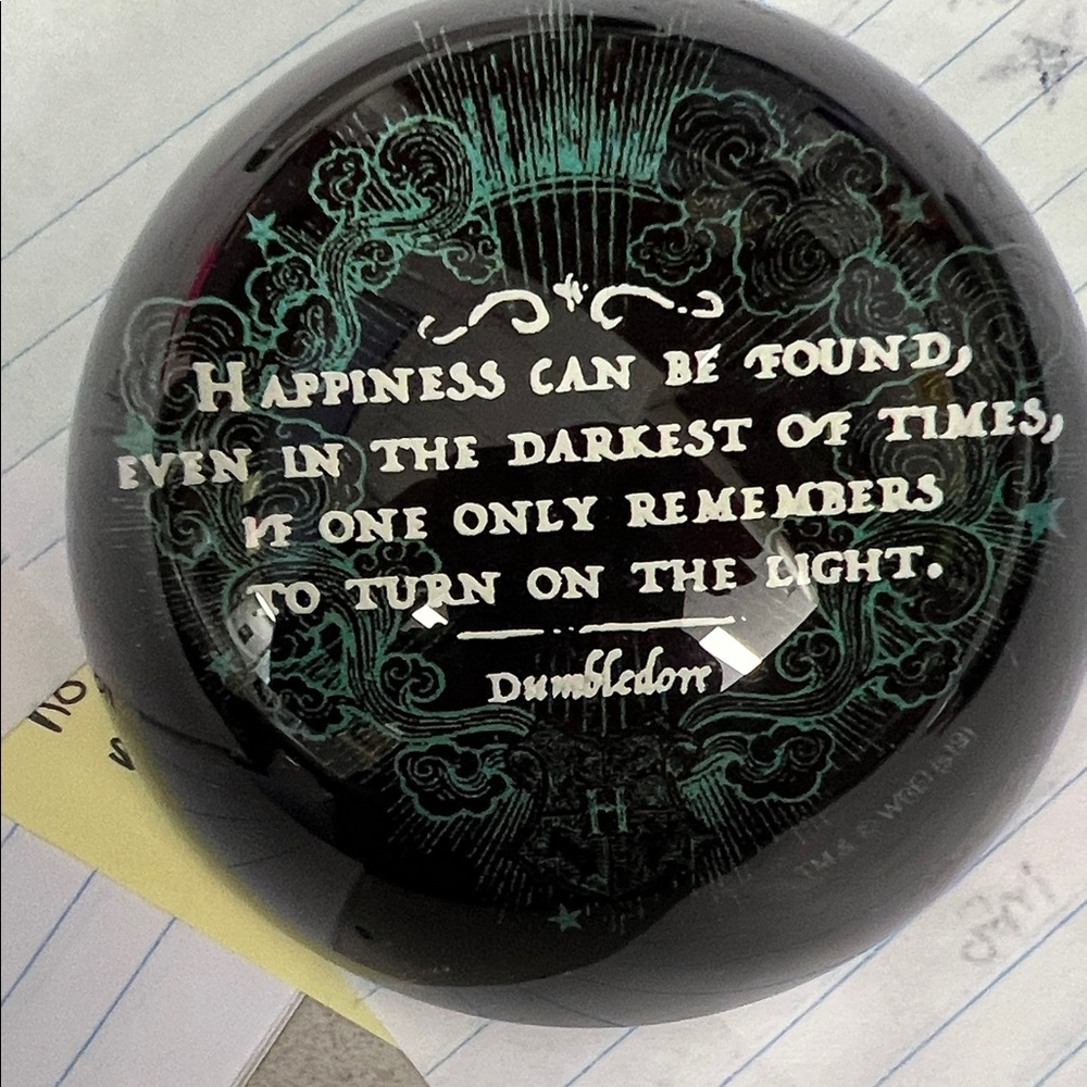 Glass paperweight with dumbledorr quote